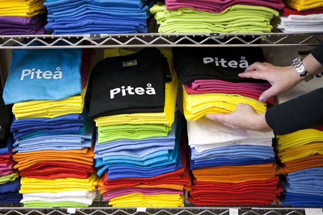 Bild över t-shirts i olika färger, Piteå Turistcenter