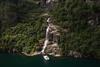 Pilagutt in front of a powerful waterfall in the Hardangerfjord – a magical place for nature experiences on the fjord.