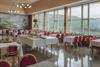 The dining room at Fossli with red chairs and a view towards the Måbødalen valley.