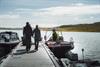 Some passengers walking on the dock towards the Halnekongen Rib-boat